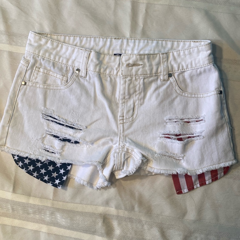 Design Lab size 24 White “cut off” jean shorts with stars and stripes pockets.